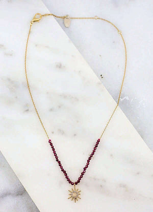 Garnet necklace with gold starburst